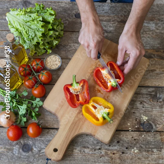 Hands Cutting Bell Pepper on Wooden Board ingredients