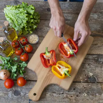 Hands Cutting Bell Pepper on Wooden Board ingredients