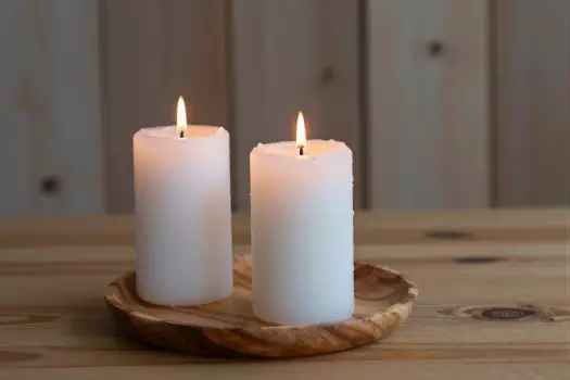Lit White Candles on Wooden Plate lit candles
