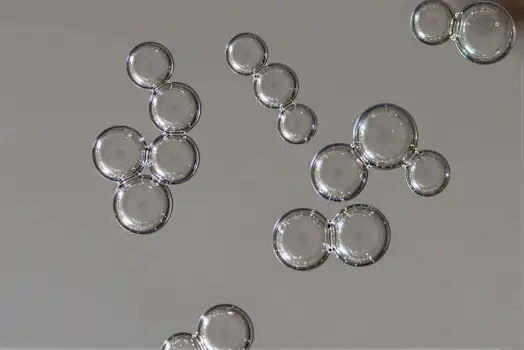 Group of Glass Objects on White Surface reflections