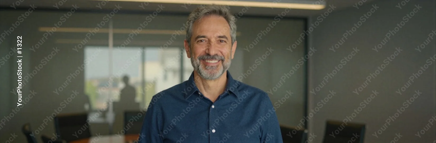 Middle-aged man smiling in modern office professional business corporate