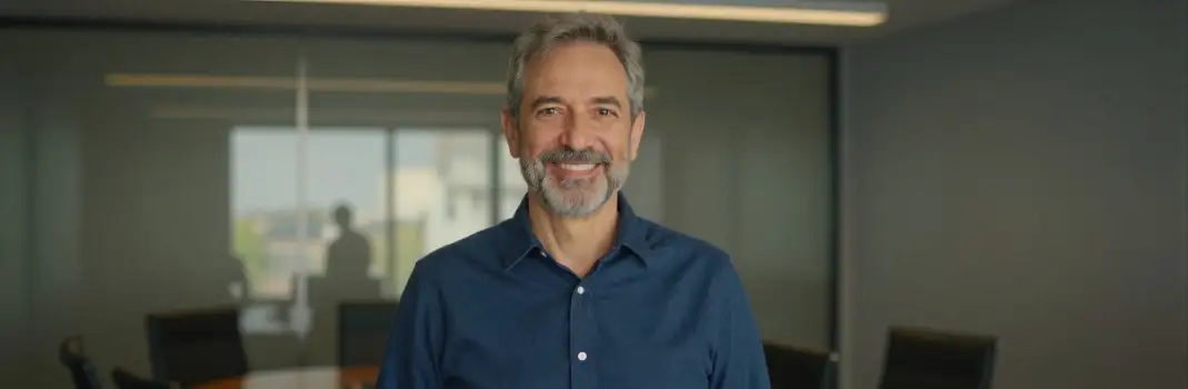 Middle-aged man smiling in modern office professional business corporate