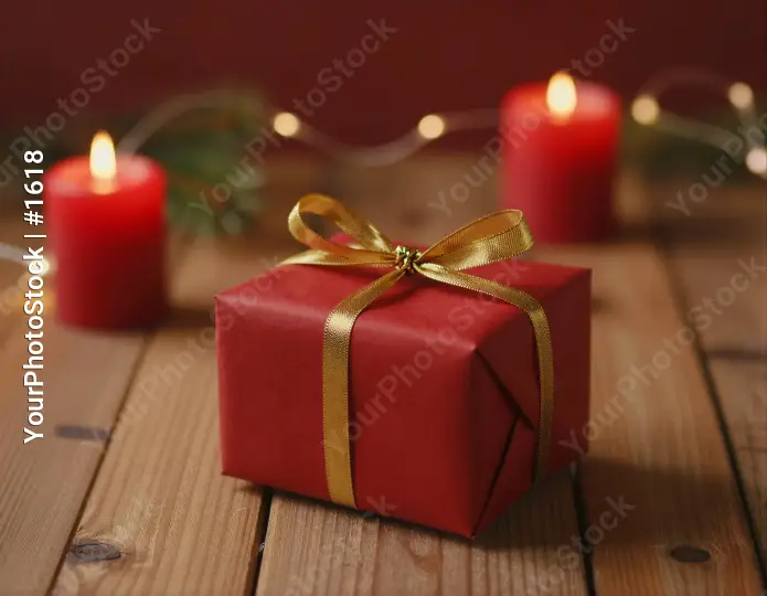 Red Gift Box with Gold Ribbon on Wood Table wooden table