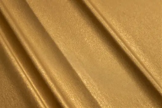 Gold Textured Fabric Close-Up metallic shiny diagonal