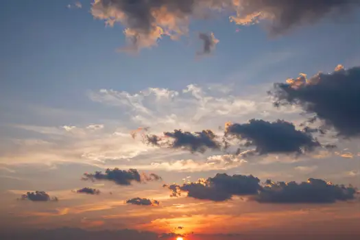Serene Sunset with Fluffy Clouds warm horizon