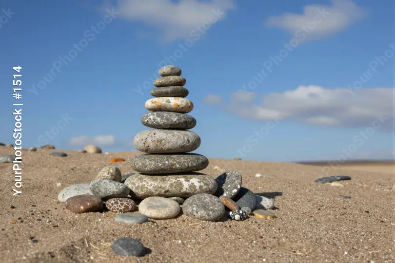 Stack of Pebbles on Sandy Beach pyramid stones