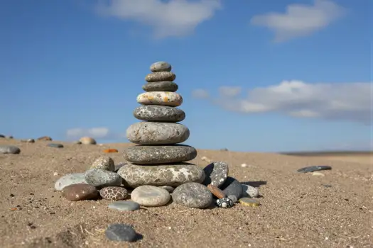 Stack of Pebbles on Sandy Beach pyramid stones