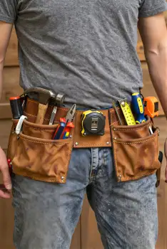 Person with Tool Belt Working on Construction Site