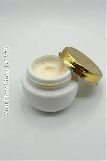 White Jar with Gold Lid Revealing Cream plastic