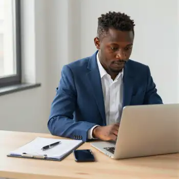 African-American Man Working at Desk laptop office