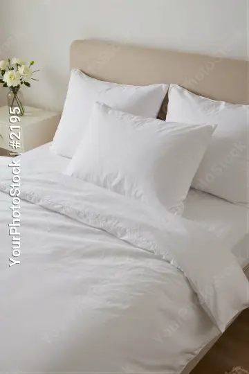 Bedroom Setup with White Sheets and Pillows minimalist hotel