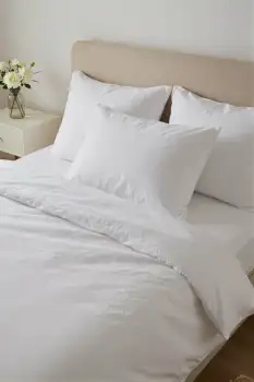 Bedroom Setup with White Sheets and Pillows minimalist hotel