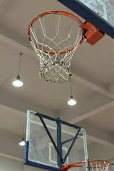 Basketball Hoop Hanging From Ceiling In Gymnasium
