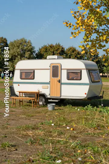 Autumnal White Caravan in Grass Field trees yellow leaves