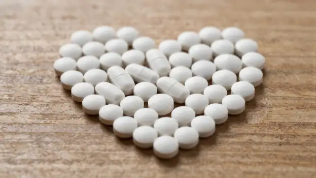 Heart-shaped Pill Bottle with White Pills