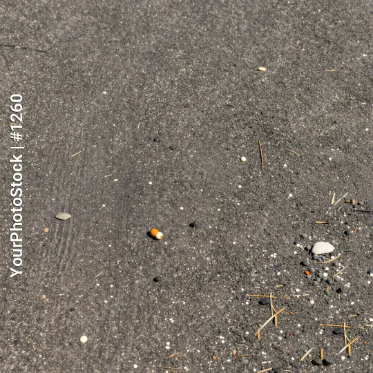 Wet Asphalt Close-Up with Debris rocks pebbles