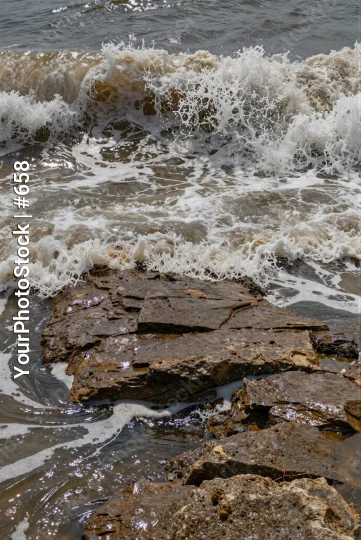 Rocky Shoreline with Crashing Waves dark blue water