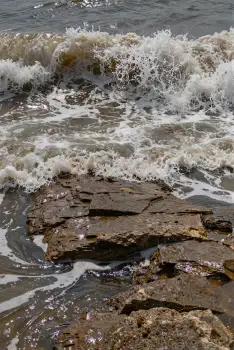 Rocky Shoreline with Crashing Waves dark blue water