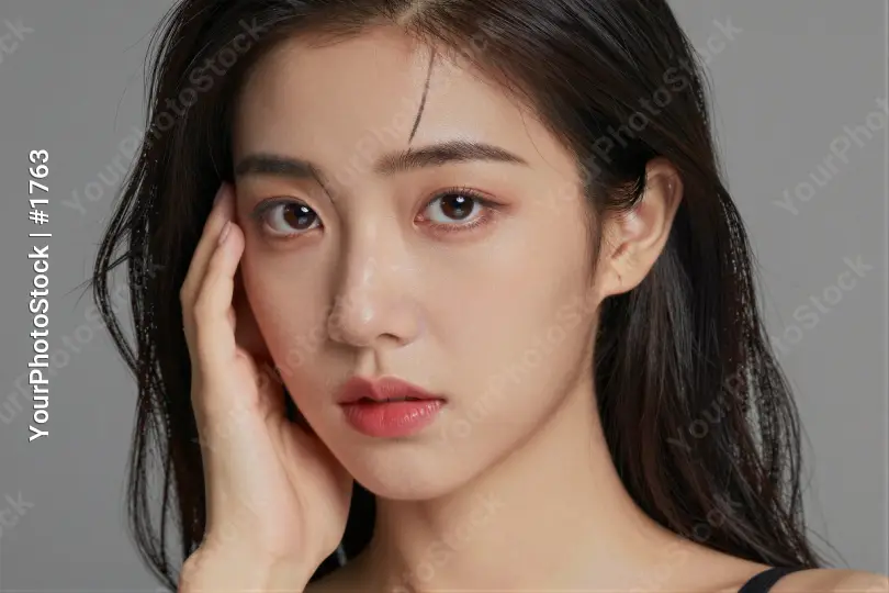 Young Asian Woman with Serious Expression Deep in Thought