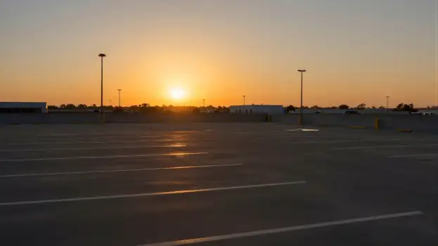 Empty Parking Lot at Sunset serene warm glow low angle shot