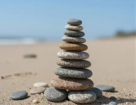 Pyramid Stack of Pebbles on Sandy Beach nature