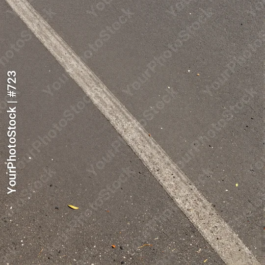 Curved white line on asphalt road with debris