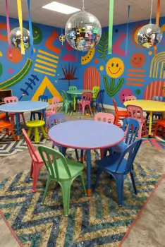 Colorful Children's Playroom with Mural and Disco Balls