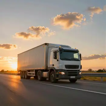 Semi-Truck Driving on Highway at Sunset empty road