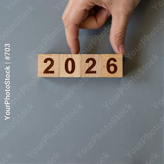Hand Holding Wooden Block With Numbers 2026 grid
