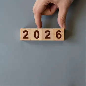 Hand Holding Wooden Block With Numbers 2026 grid