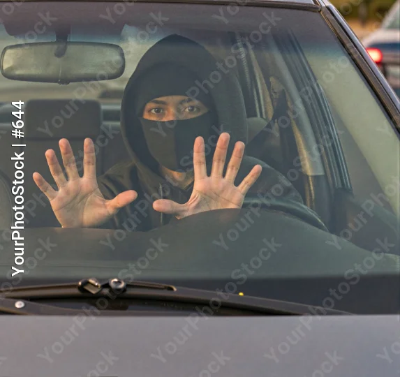 Person in Black Making Stop Gesture in Car thief