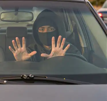 Person in Black Making Stop Gesture in Car thief
