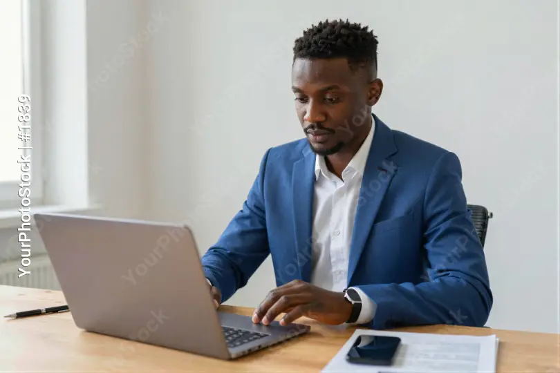 African-American Man Working at Desk laptop office