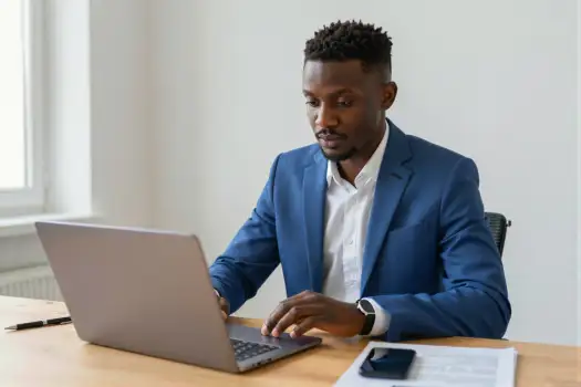 African-American Man Working at Desk laptop office