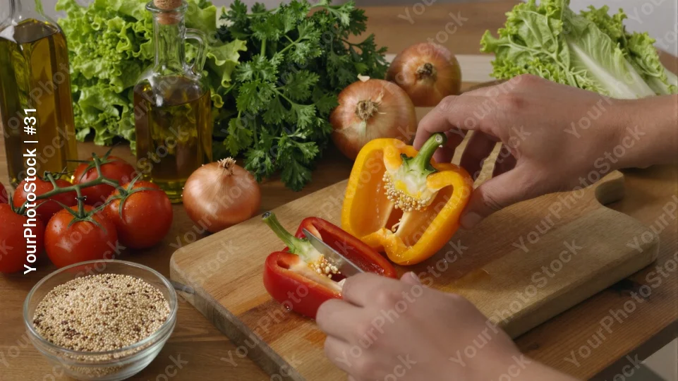 Person Peeling Red Bell Pepper on Cutting Board