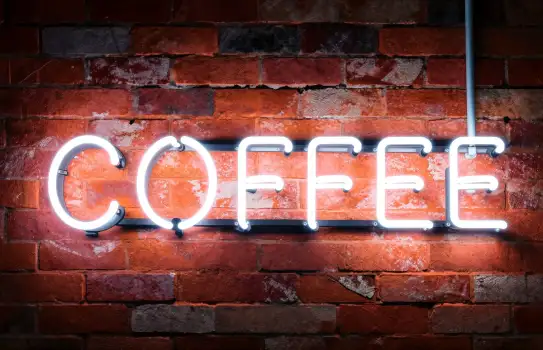 Neon Coffee Sign on Brick Wall