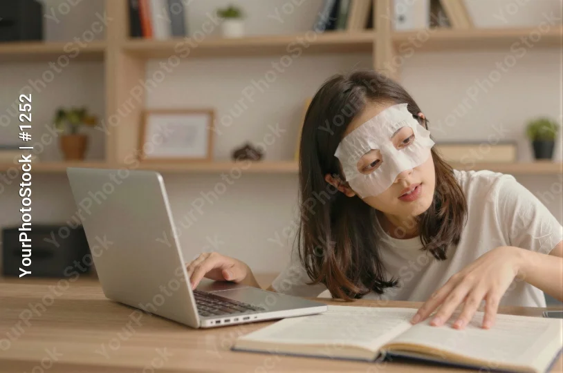 Young Woman Working at Desk laptop typing notebook