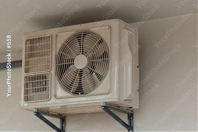 Outdoor Air Conditioning Unit Mounted on White Wall
