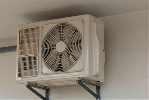 Outdoor Air Conditioning Unit Mounted on White Wall