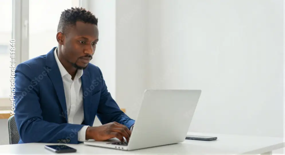 African-American Man Working Intently at Desk