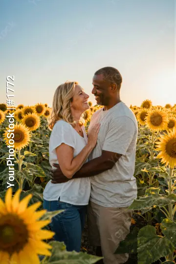 couple embracing in a field of sunflowers at sunset