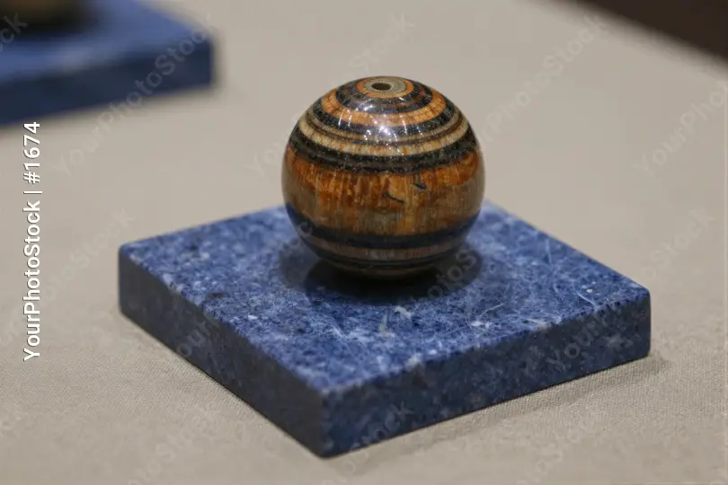 Wooden striped coaster on blue base beige background