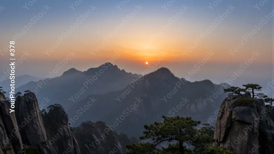 Mountain Range at Sunrise with Foggy Peaks sunset