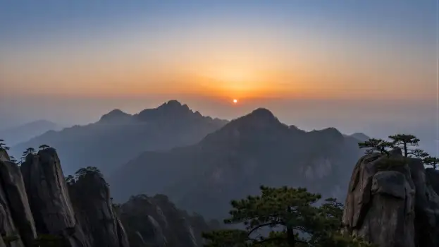 Mountain Range at Sunrise with Foggy Peaks sunset