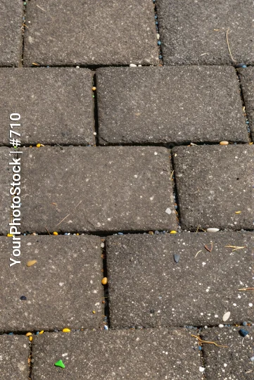 Close-up of a brick pavement with debris asphalt