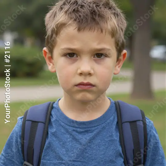 Young Boy in Park with Serious Expression blue t-shirt kid