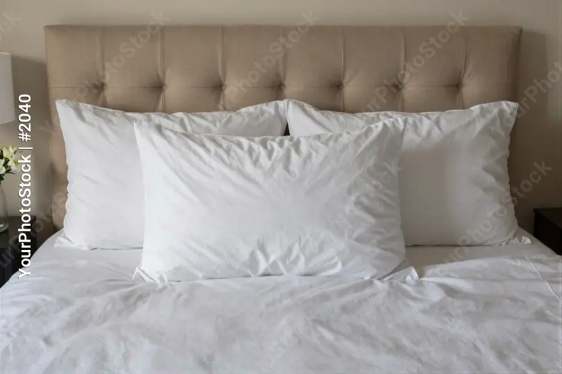 Bedroom Setup with Tufted Headboard and Lamp white sheets hotel