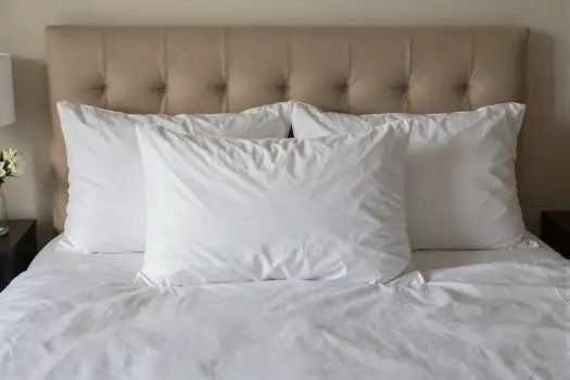 Bedroom Setup with Tufted Headboard and Lamp white sheets hotel