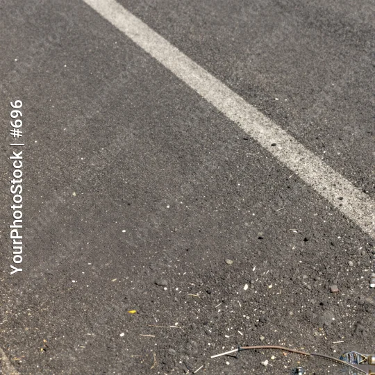 Empty Road with White Line and Debris low angle