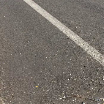 Empty Road with White Line and Debris low angle